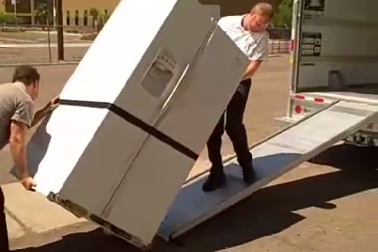 Easing a wrapped refrigerator down the ramp