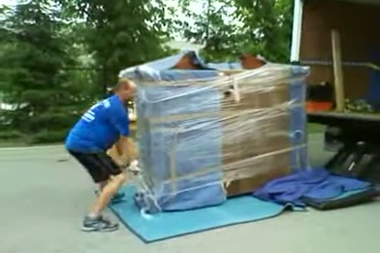 Shrink-wrapping a dresser at the truck